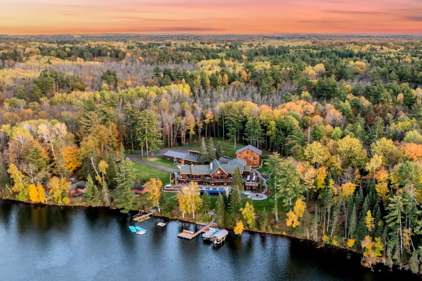 Aerial view of the estate in autumn color with docks on Long Lake